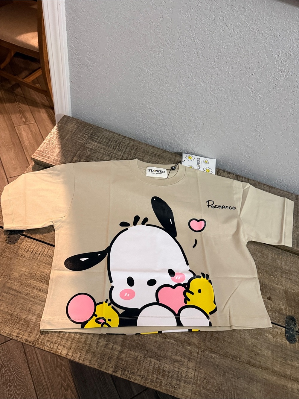 Pochaco Graphic Short-Sleeve Cropped Tee in Beige with Pink Accents